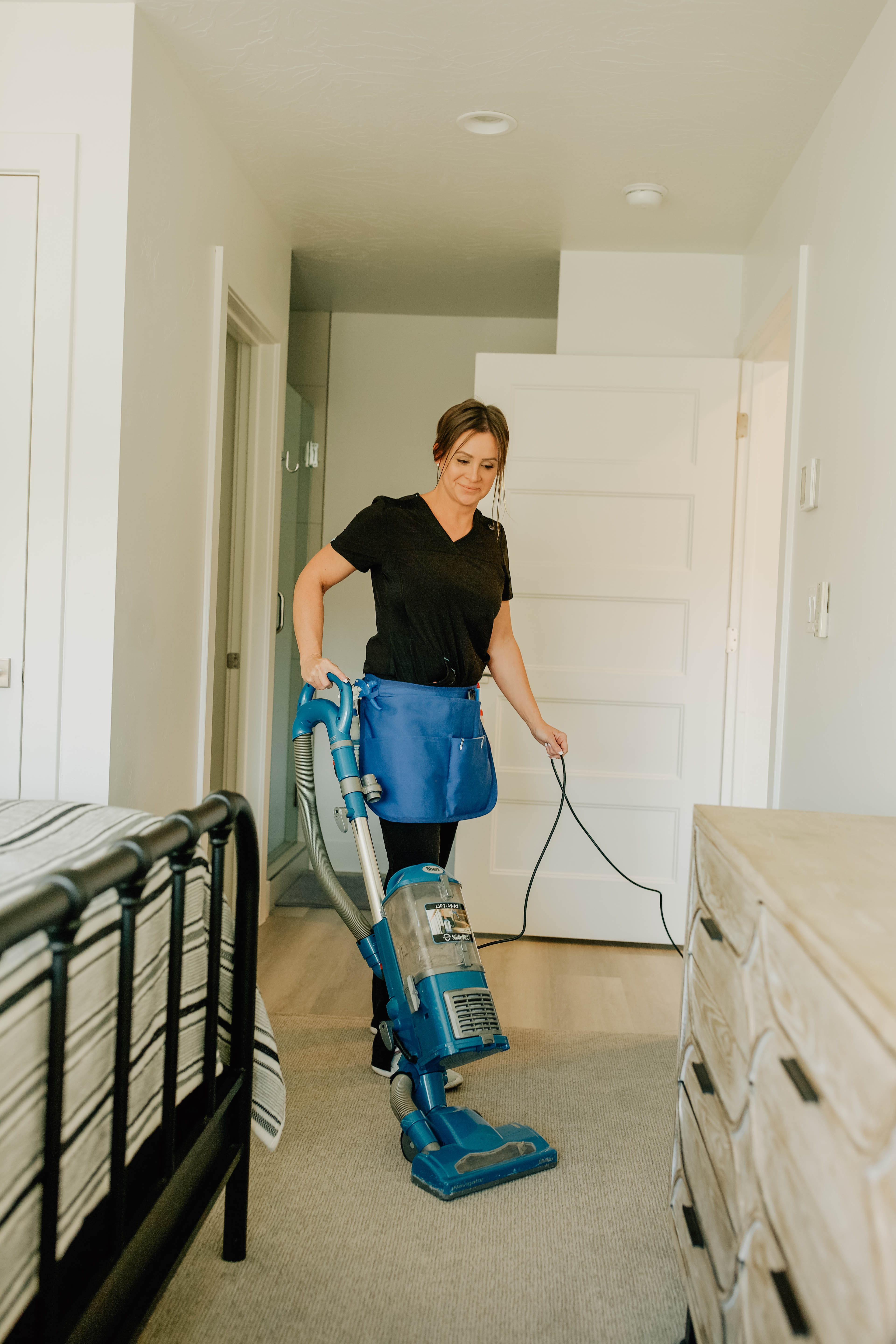 Better Home Cleaning professional with cleaning supplies